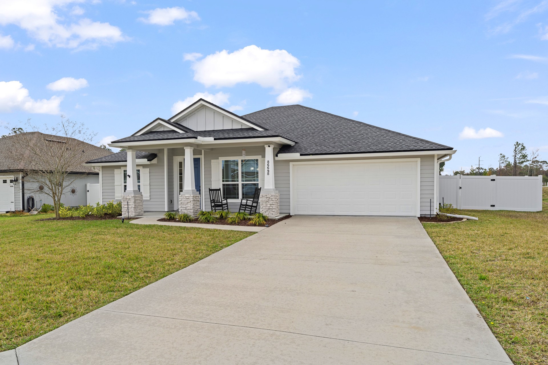 86645 Lazy Lake Circle Yulee, FL 32097 - Photo 2 of 44 a front view of a house with a garden and yard