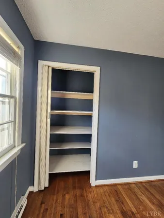 a kitchen with a sink window and cabinets