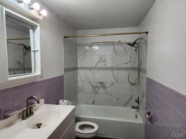 a bathroom with a sink a mirror and a shower