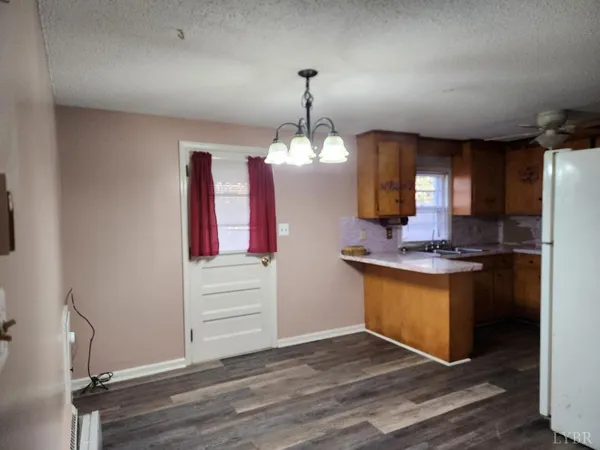 a kitchen with a sink cabinets and wooden floor
