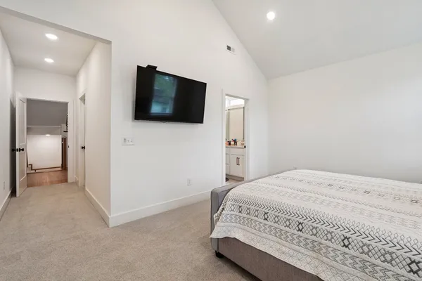 a bedroom with a bed and a flat screen tv