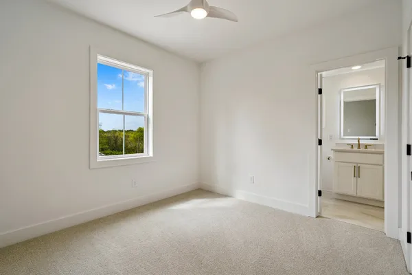 an empty room with windows and closet