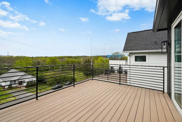 a view of a balcony with wooden floor and city view