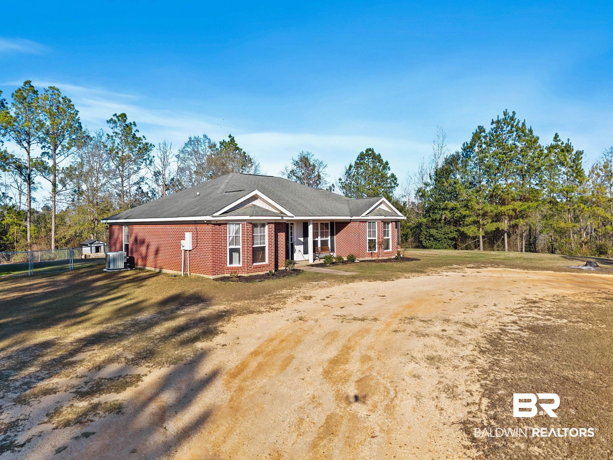 55750 Lottie Road Perdido, AL 36562 - Photo 79 of 84 View of front of home with a front lawn, brick siding, and a porch