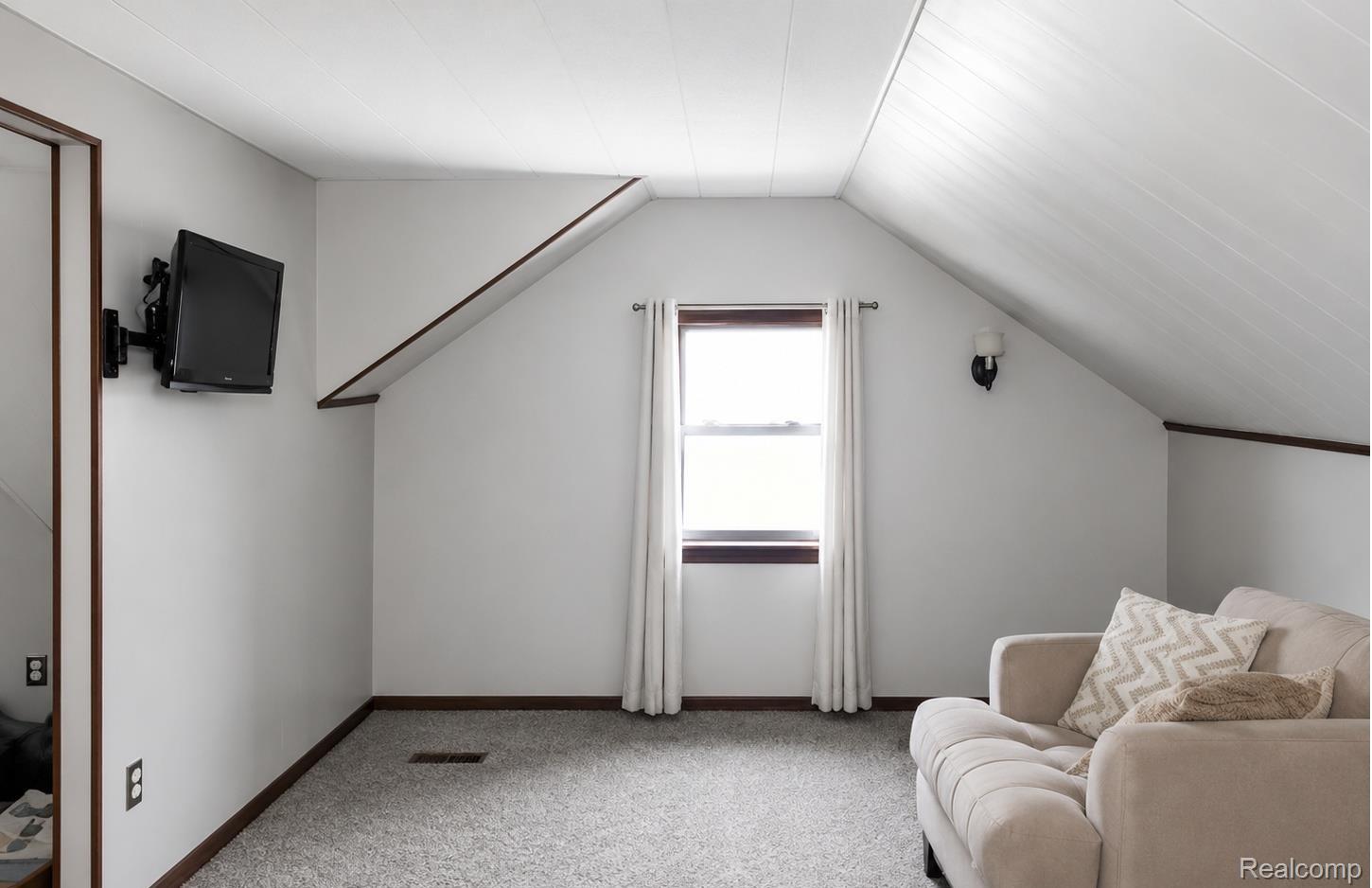 9552 Wayne Road Livonia, MI 48150 - Photo 12 of 31 Upper Bedroom 2ND Flexible upper-level bedroom and lounge area with charming sloped ceilings, comfortable living space, and a private second-floor layout ideal for relaxing, guests, or everyday living.