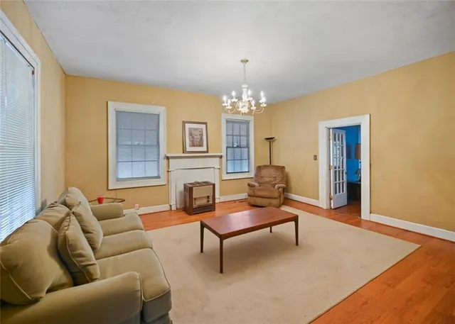 a living room with furniture and a chandelier