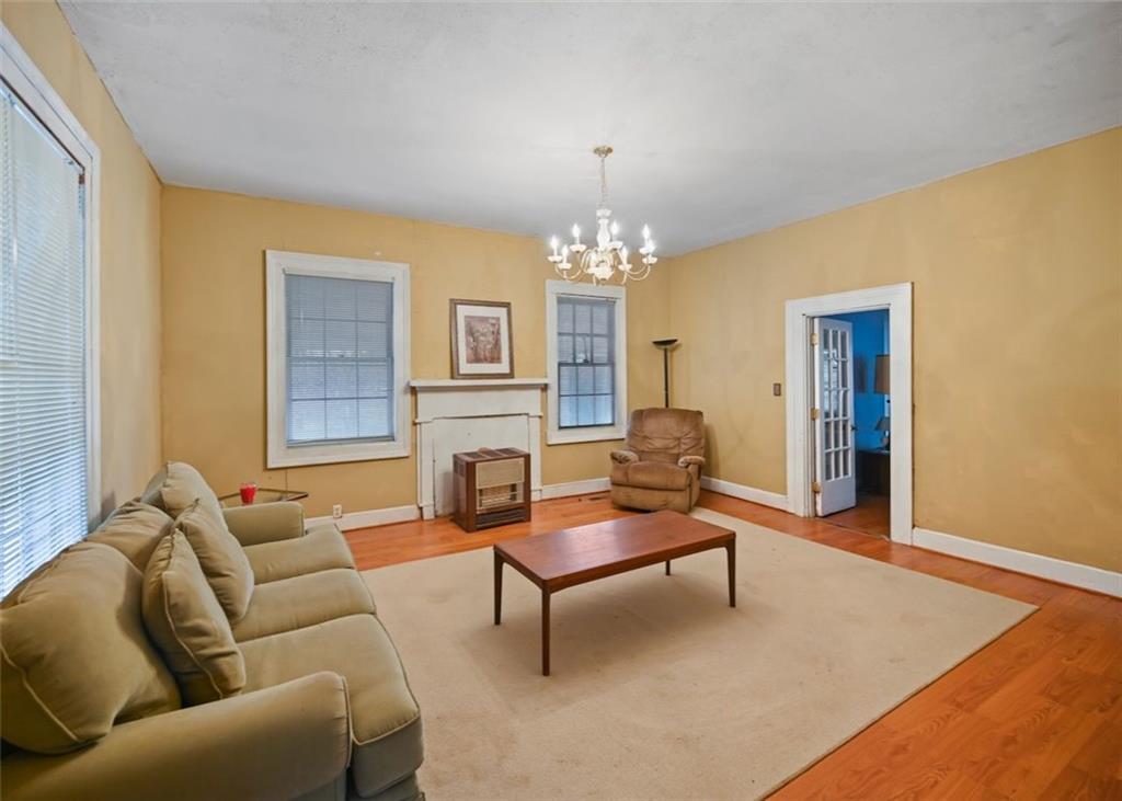 4000 Bostwick Road Madison, GA 30650 - Photo 19 of 34 a living room with furniture and a chandelier