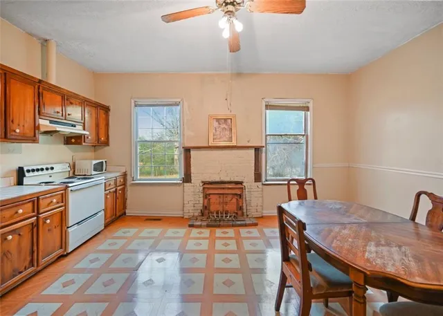 a kitchen with a table chairs and a stove
