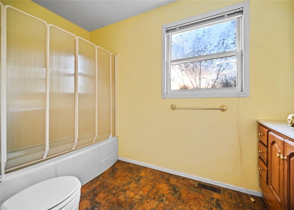 4000 Bostwick Road Madison, GA 30650 - Photo 26 of 34 a bathroom with a window and a shower