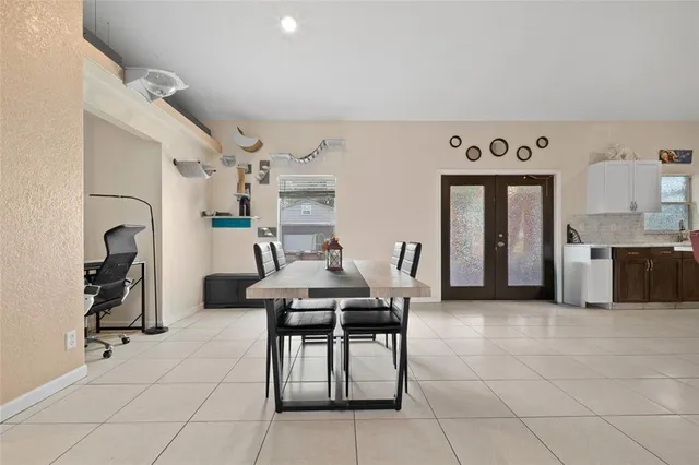 a living room with furniture a dining table and chairs