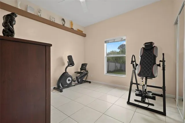 a view of a room with gym equipment and a large window