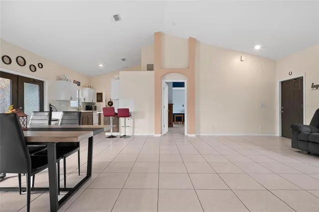 a kitchen with cabinets and chairs