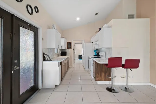 a large kitchen with a sink and cabinets