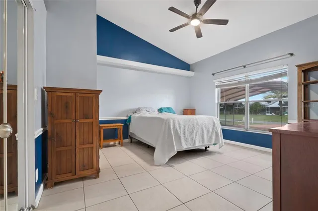 a bedroom with a bed and a chair