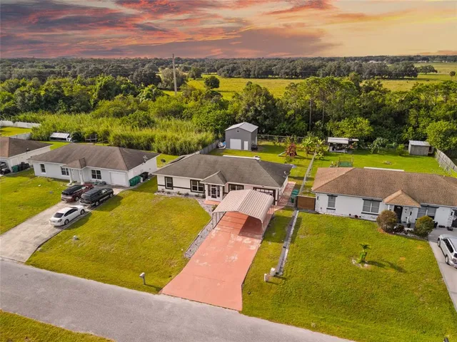 an aerial view of residential houses with outdoor space and swimming pool