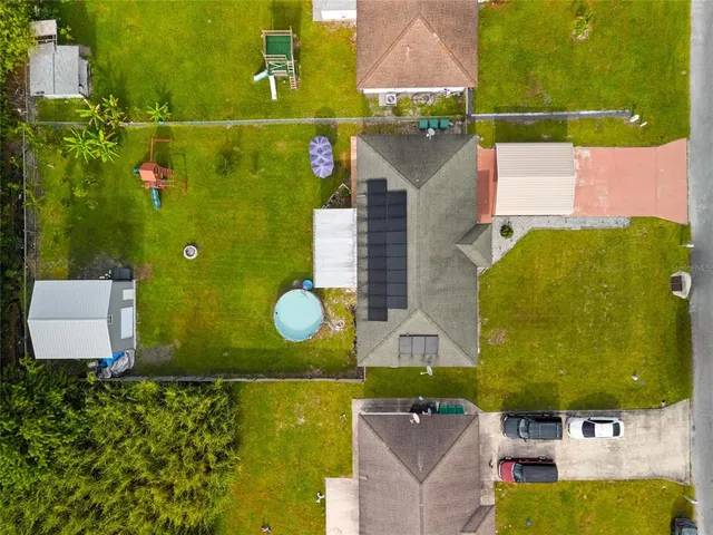 an aerial view of a house with a swimming pool
