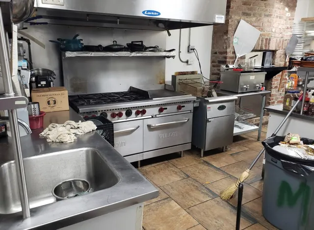 a white stove top oven sitting inside of a kitchen