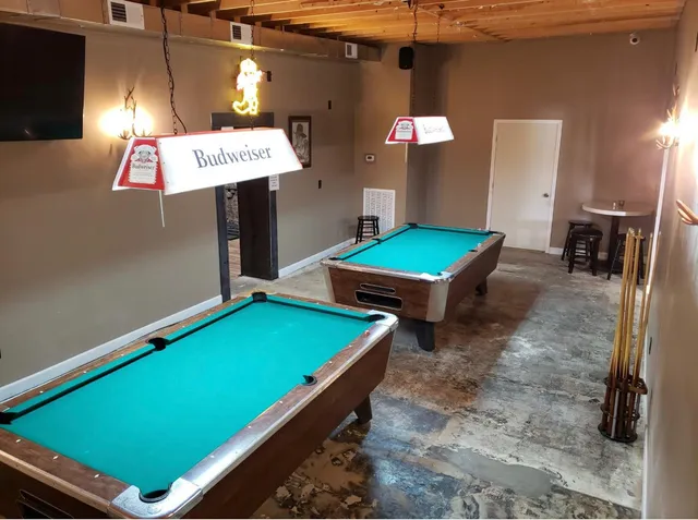 a room with pool table and windows