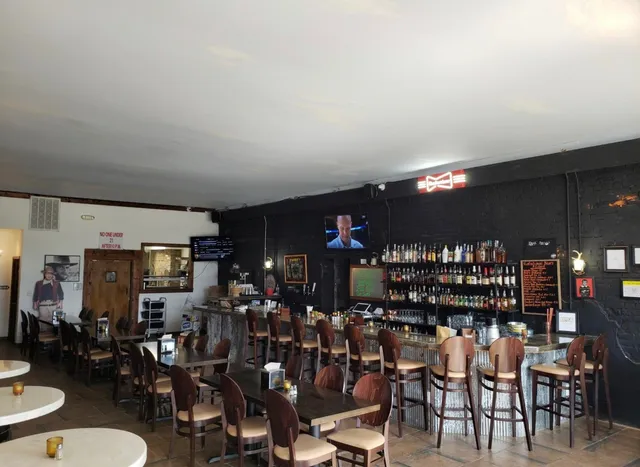 a view of a room with lots of chairs and mirrors