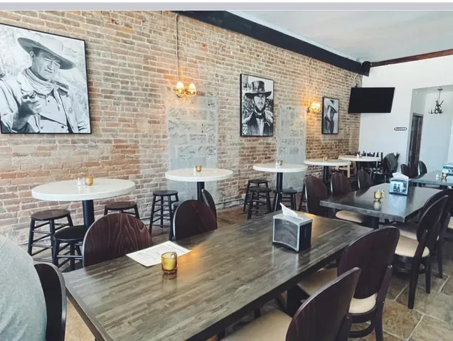 a dining room with furniture and wooden floor