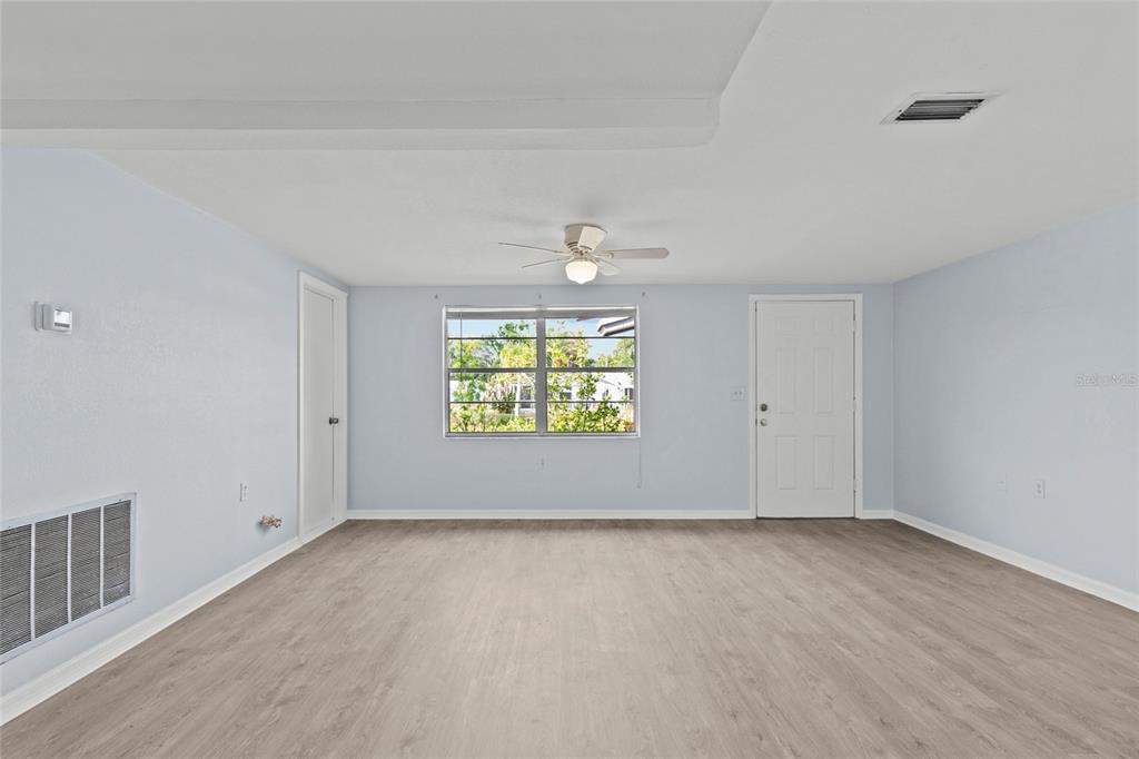 1623 Plum Tree Road Holiday, FL 34690 - Photo 11 of 33 wooden floor in an empty room with a window