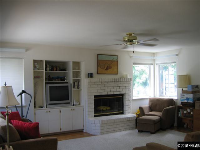 4390 Bitteroot Road Reno, NV 89519 - Photo 3 of 9 a living room with furniture and a fireplace