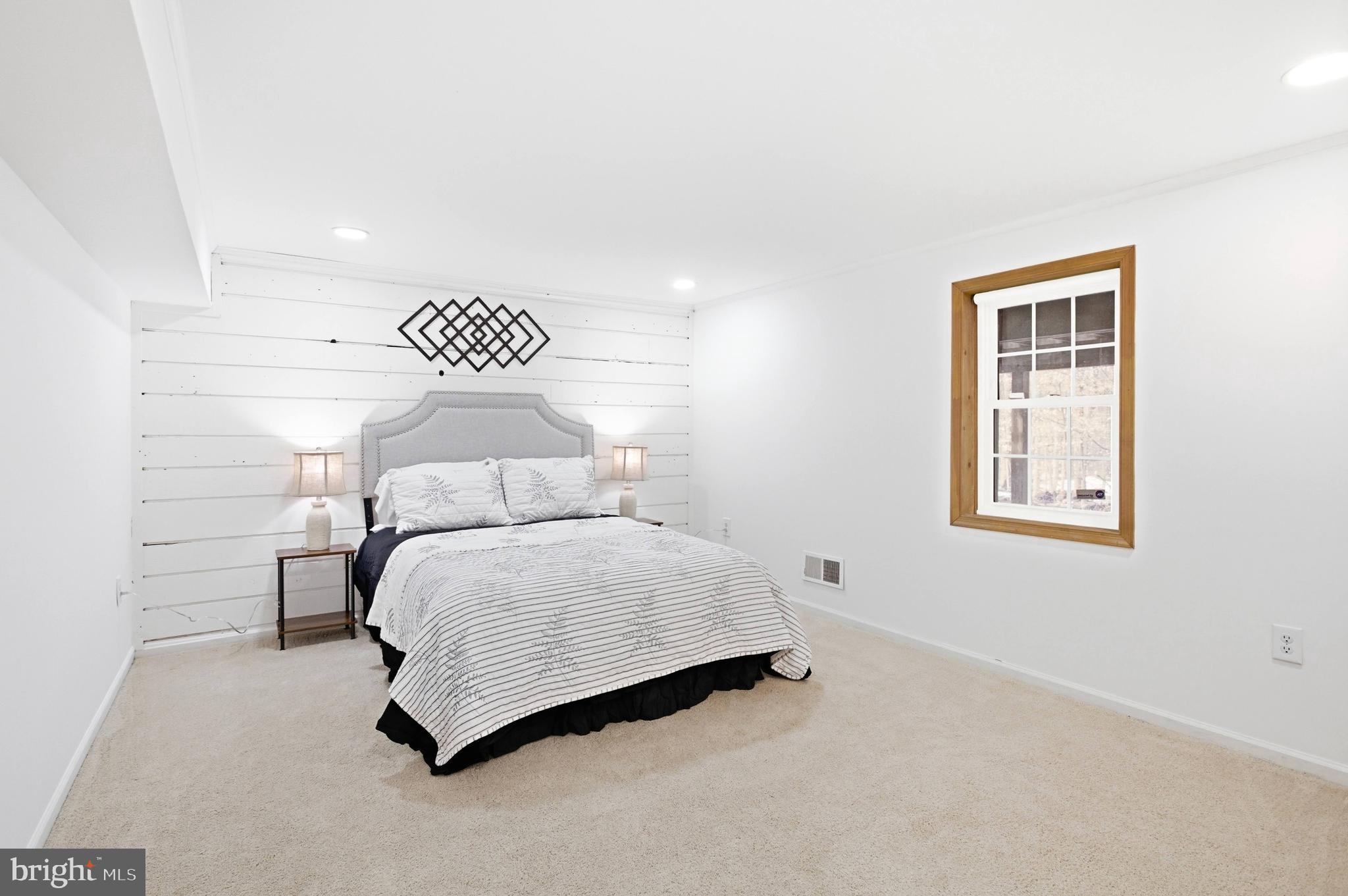 11316 Robert Carter Road Fairfax Station, VA 22039 - Photo 18 of 56 a bedroom with a bed and a wall painting