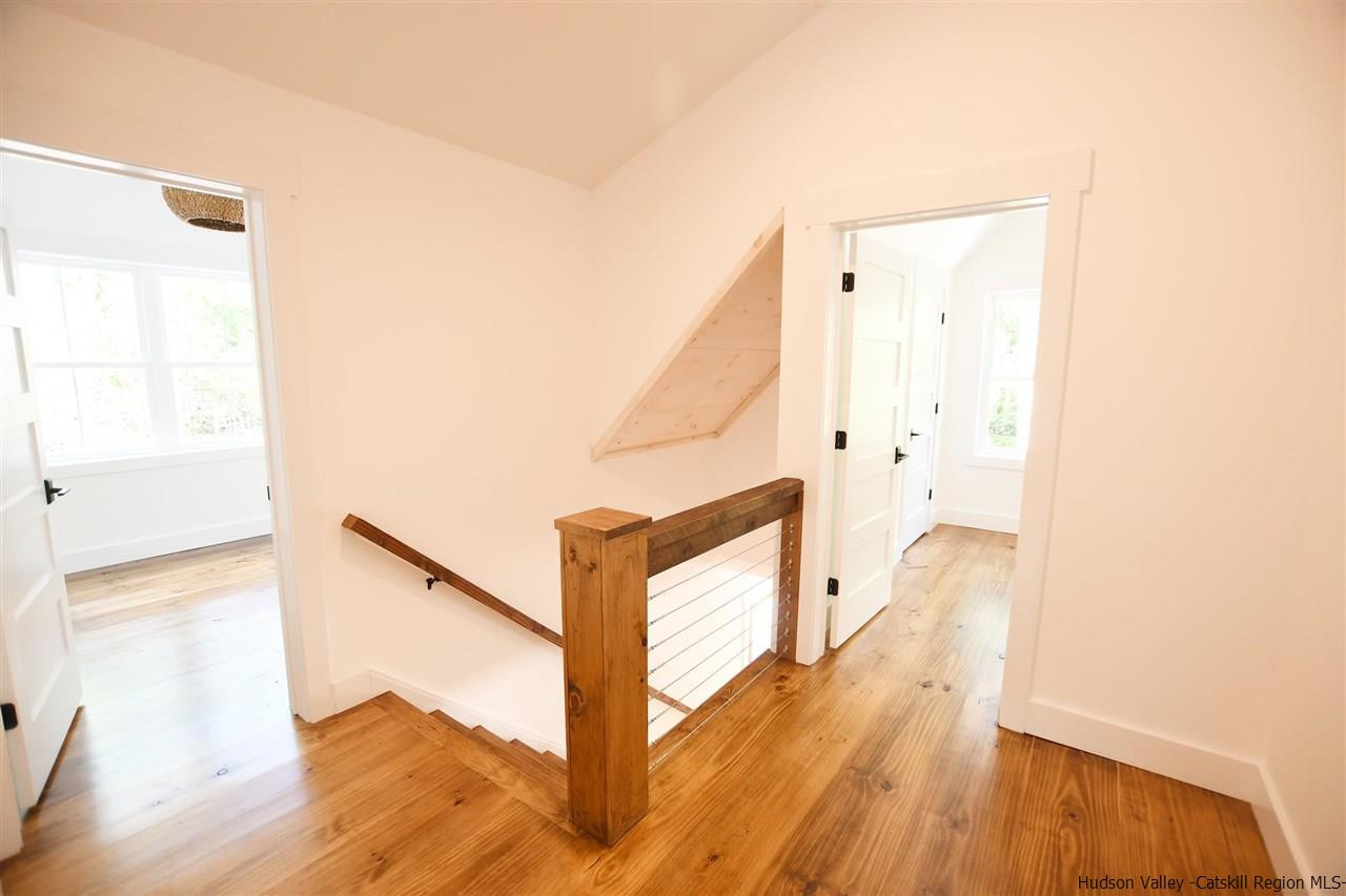 259 Rivka Road Saugerties, NY 12477 - Photo 12 of 29 a view of a hallway with wooden floor and staircase