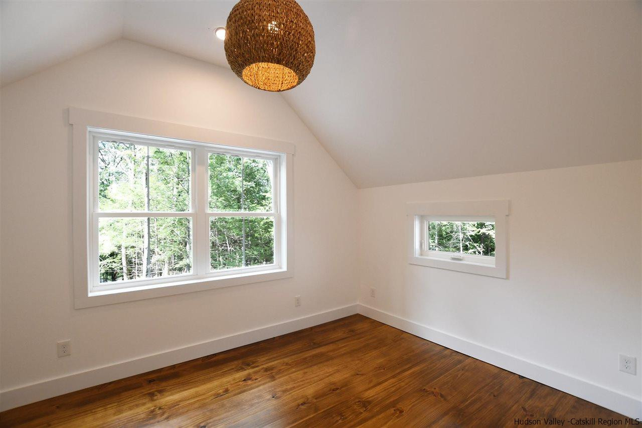 259 Rivka Road Saugerties, NY 12477 - Photo 14 of 29 a view of an empty room with wooden floor and a window