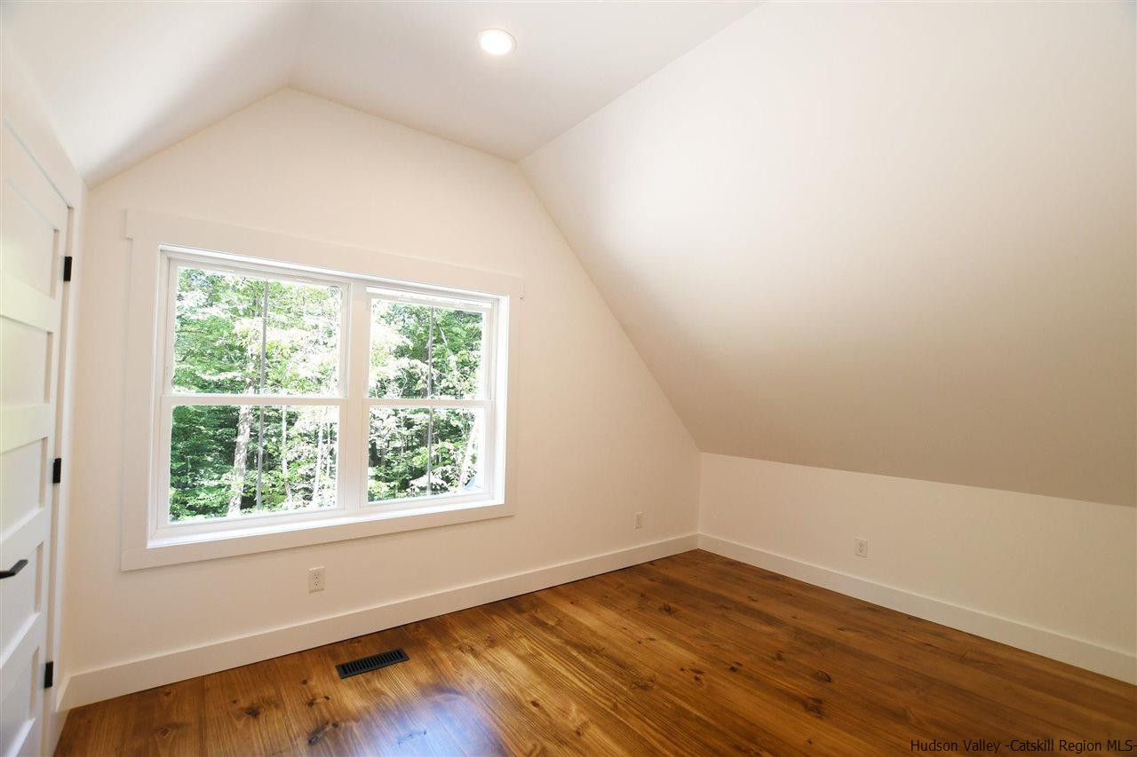 259 Rivka Road Saugerties, NY 12477 - Photo 15 of 29 an empty room with wooden floor and windows