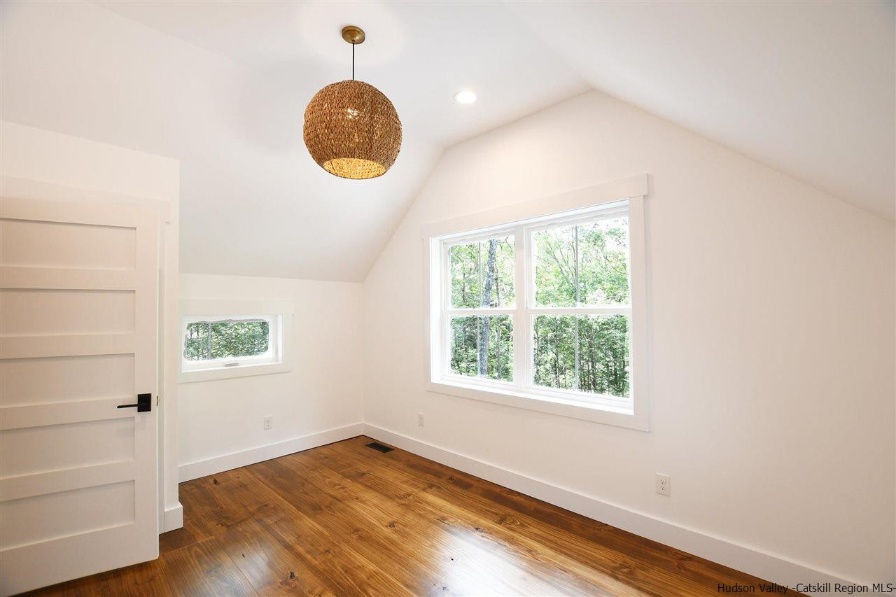 259 Rivka Road Saugerties, NY 12477 - Photo 16 of 29 an empty room with wooden floor and windows