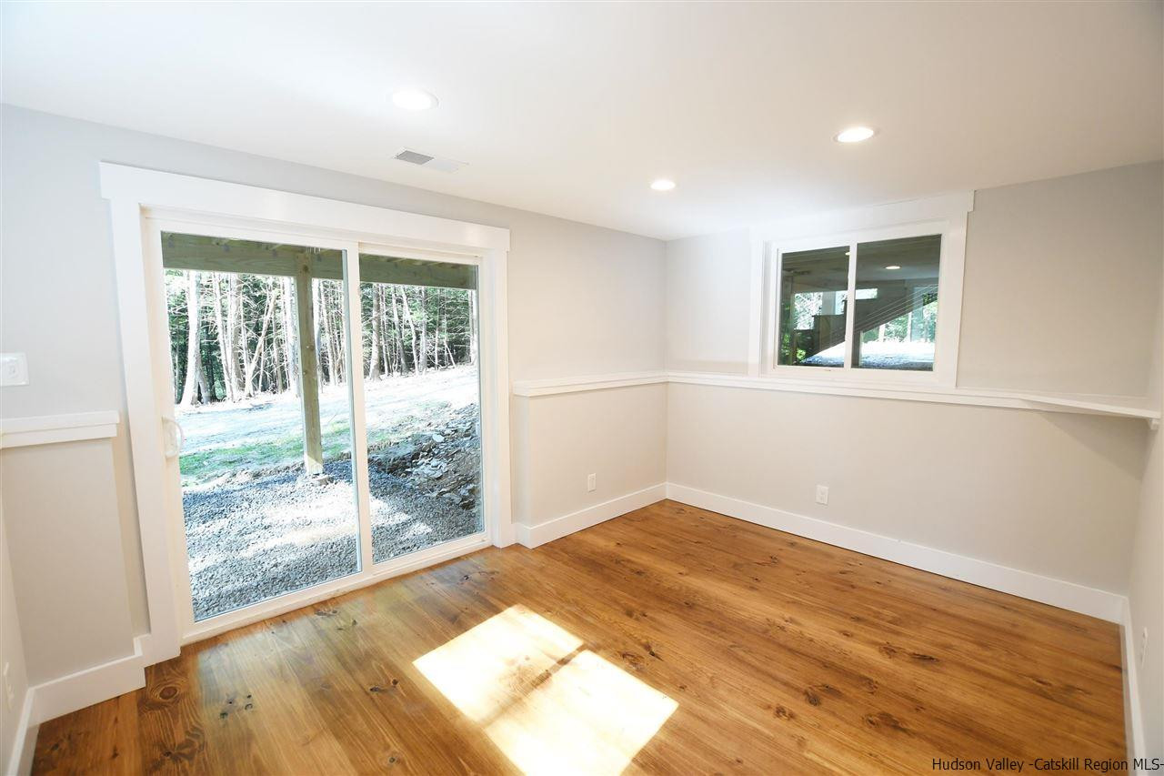 259 Rivka Road Saugerties, NY 12477 - Photo 20 of 29 a view of an empty room with wooden floor and a window