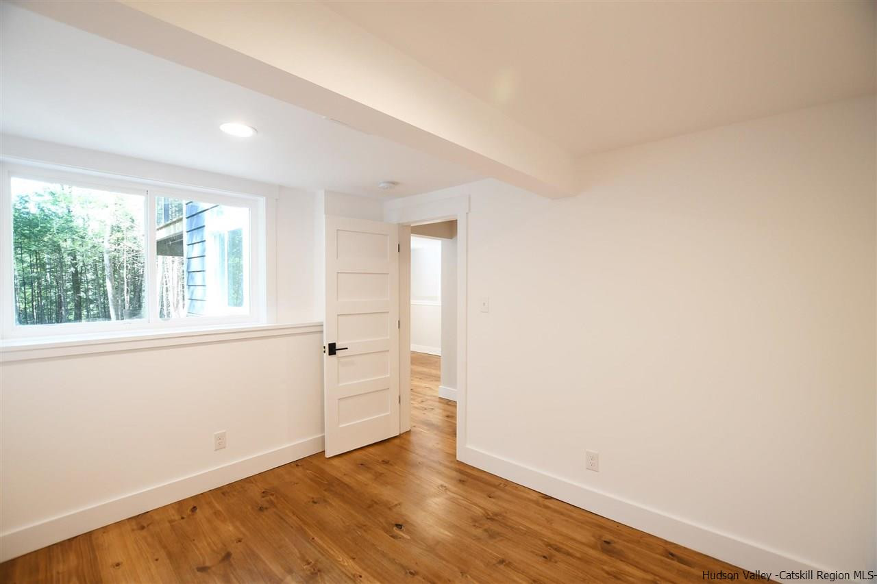 259 Rivka Road Saugerties, NY 12477 - Photo 21 of 29 an empty room with wooden floor and windows