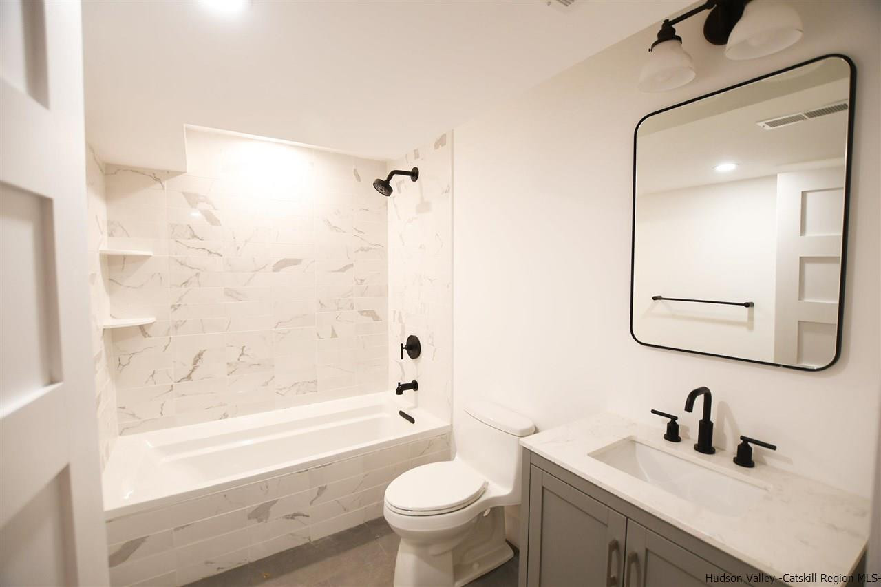 259 Rivka Road Saugerties, NY 12477 - Photo 23 of 29 a bathroom with a sink a toilet and a mirror