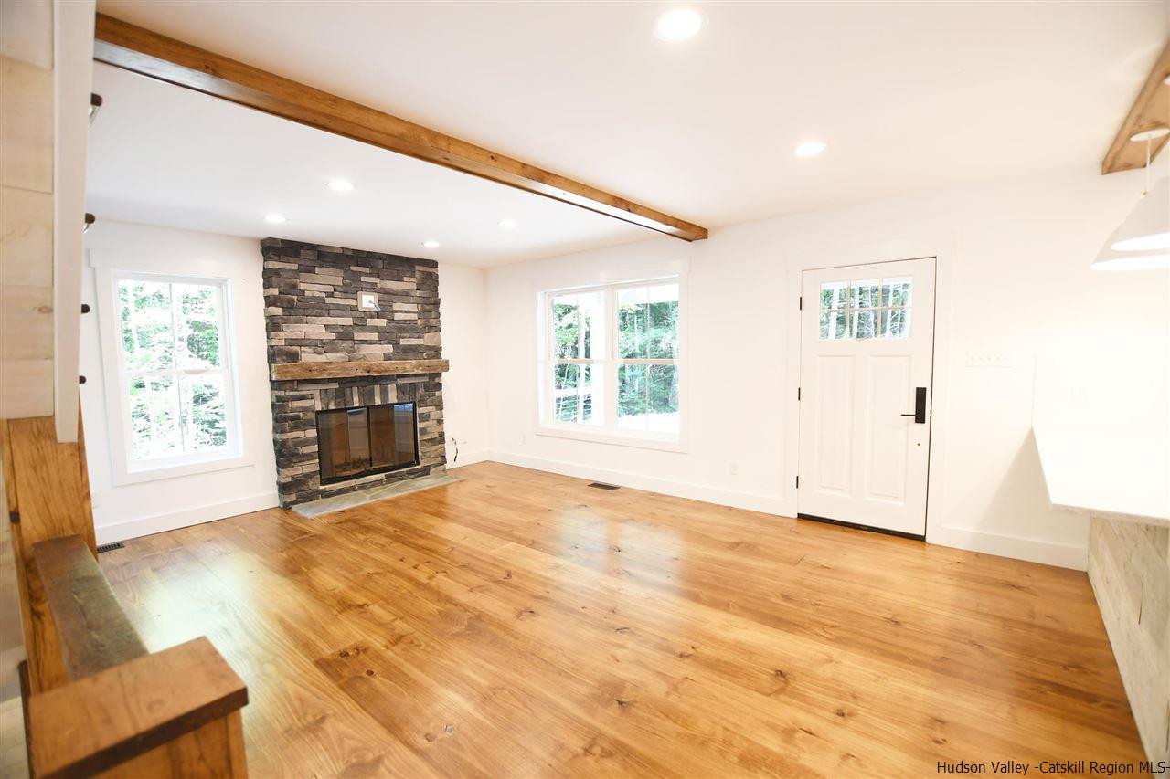 259 Rivka Road Saugerties, NY 12477 - Photo 3 of 29 a view of an empty room with a fireplace and a window