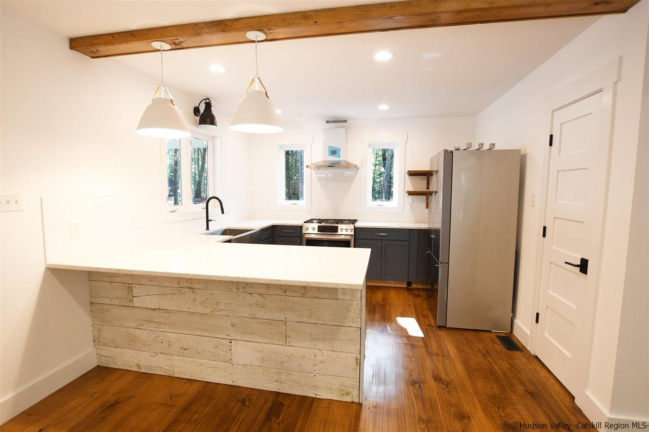 259 Rivka Road Saugerties, NY 12477 - Photo 8 of 29 a kitchen with stainless steel appliances a refrigerator and a stove top oven