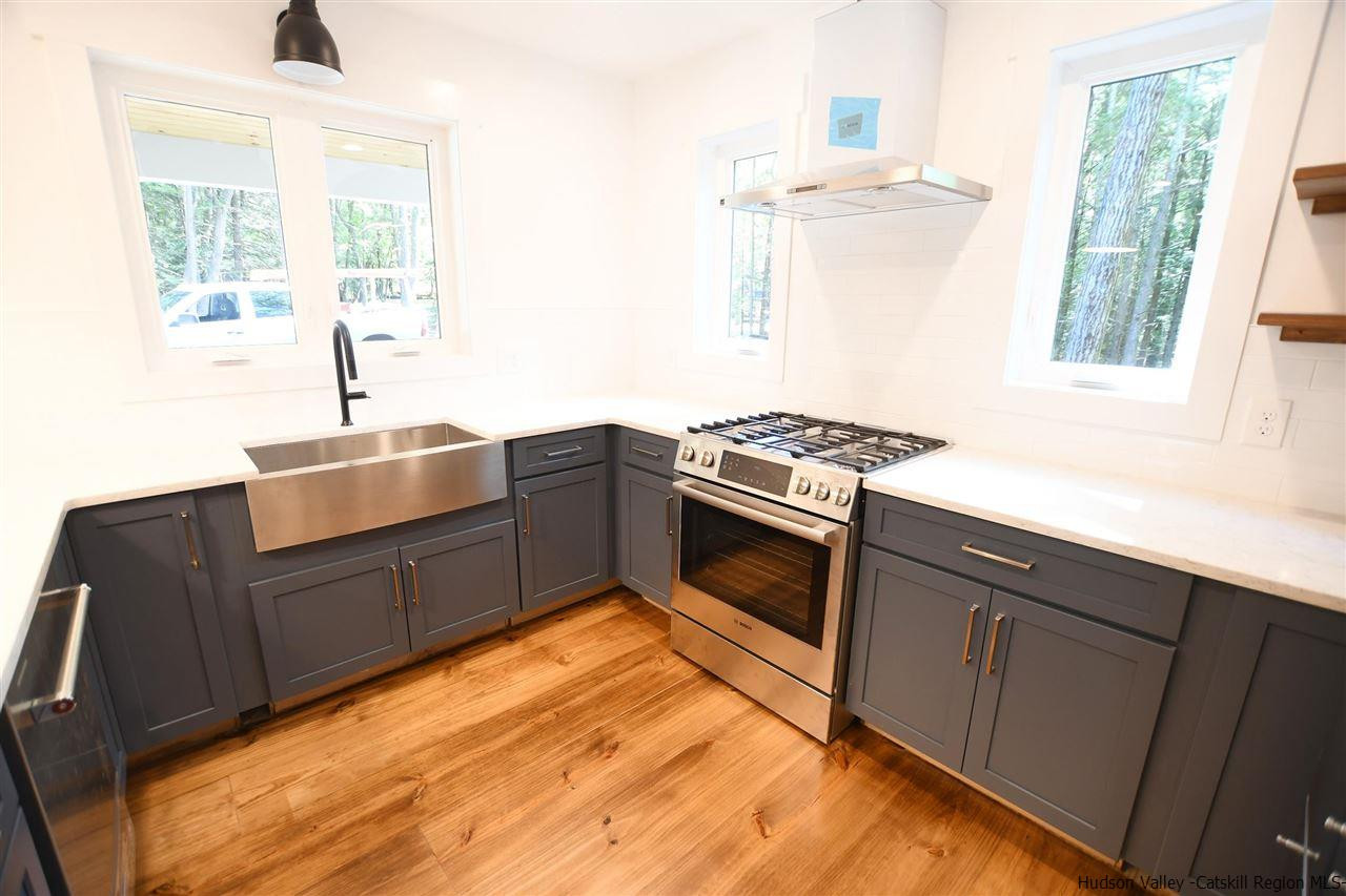 259 Rivka Road Saugerties, NY 12477 - Photo 9 of 29 a kitchen with stainless steel appliances granite countertop a stove a sink and a microwave
