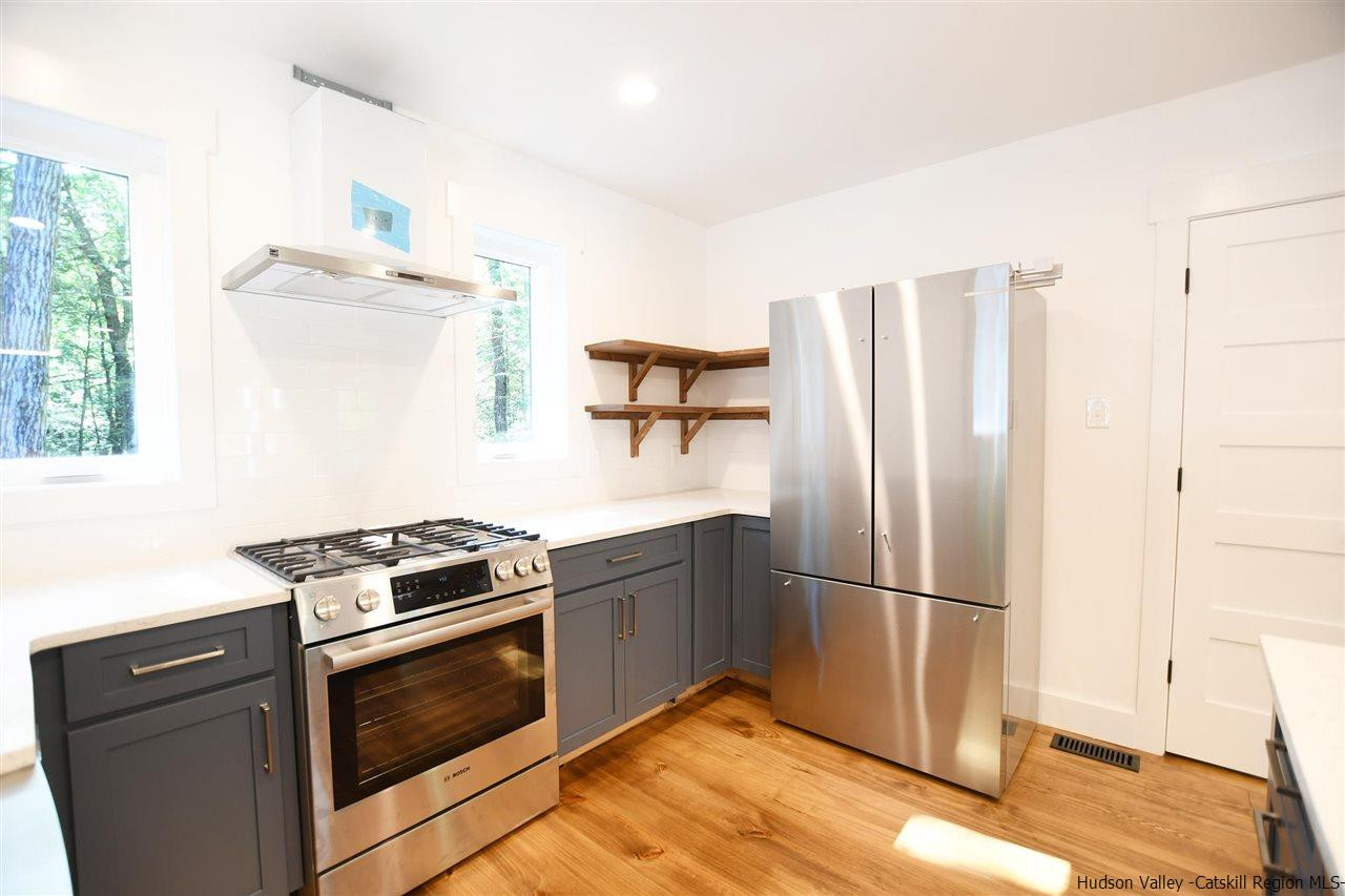 259 Rivka Road Saugerties, NY 12477 - Photo 10 of 29 a kitchen with granite countertop a refrigerator stove and microwave