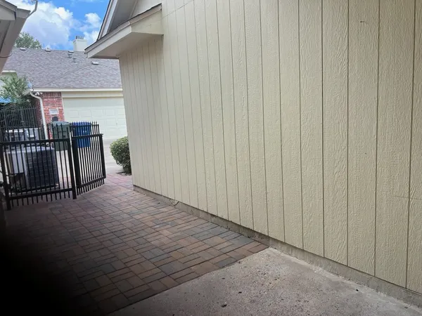 a view of a porch with wooden floor and fence
