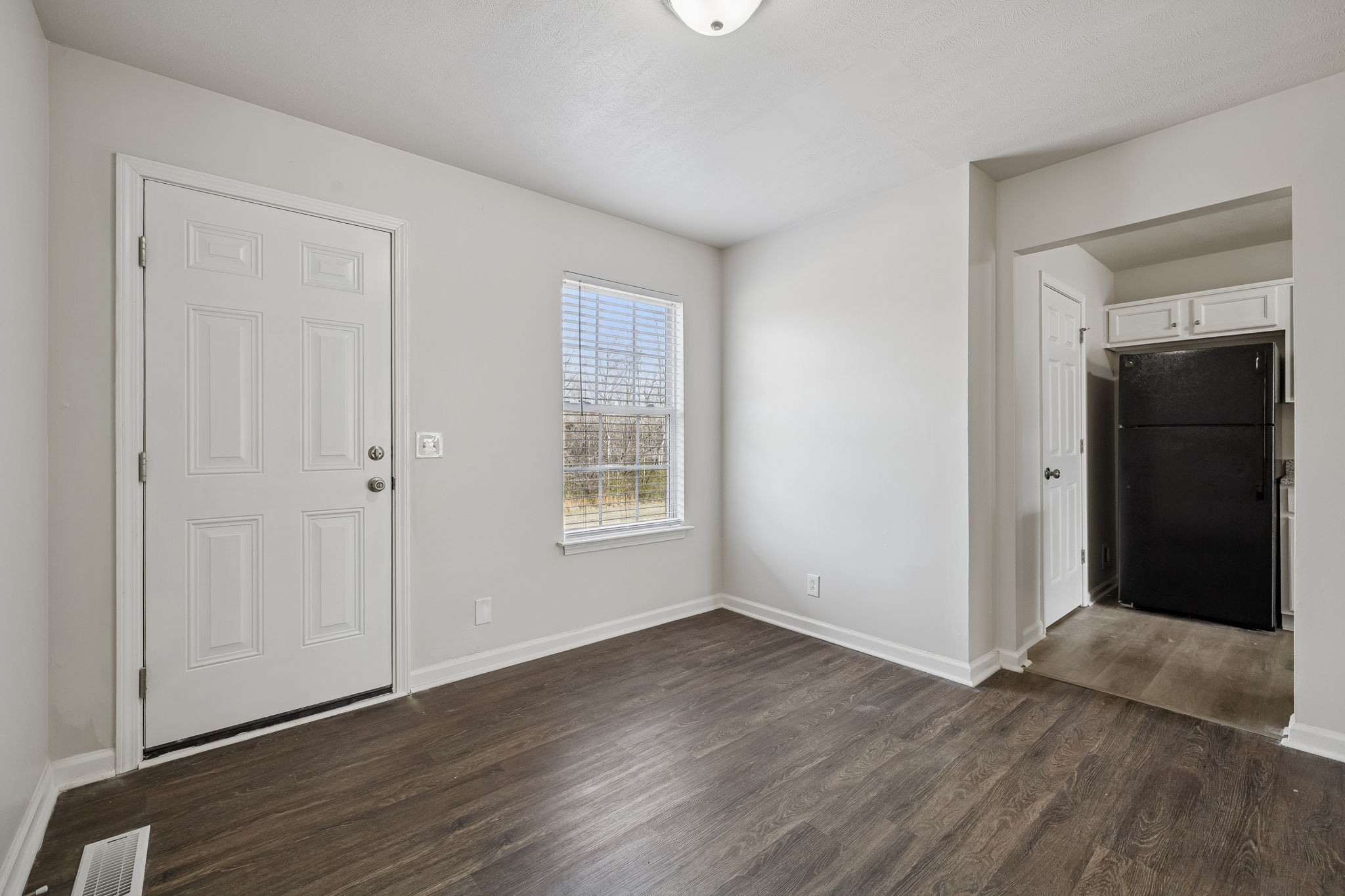 2607 Landrum Court Springfield, TN 37172 - Photo 13 of 37 a view of an empty room with wooden floor and a window