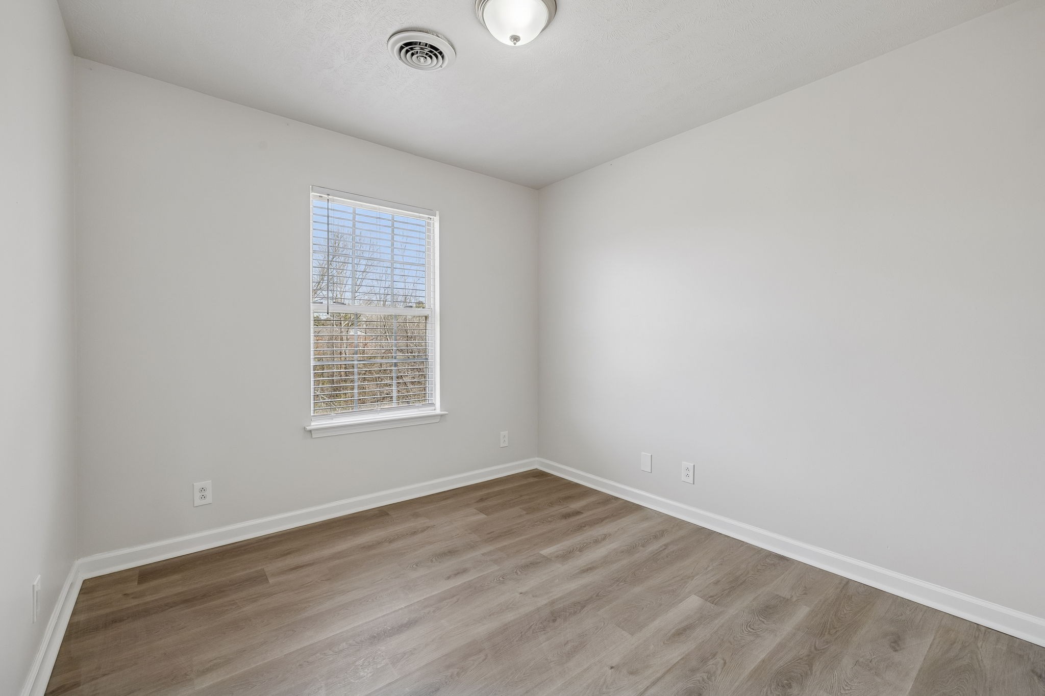 2607 Landrum Court, Unit 16 Springfield, TN 37172 - Photo 21 of 30 an empty room with wooden floor and windows