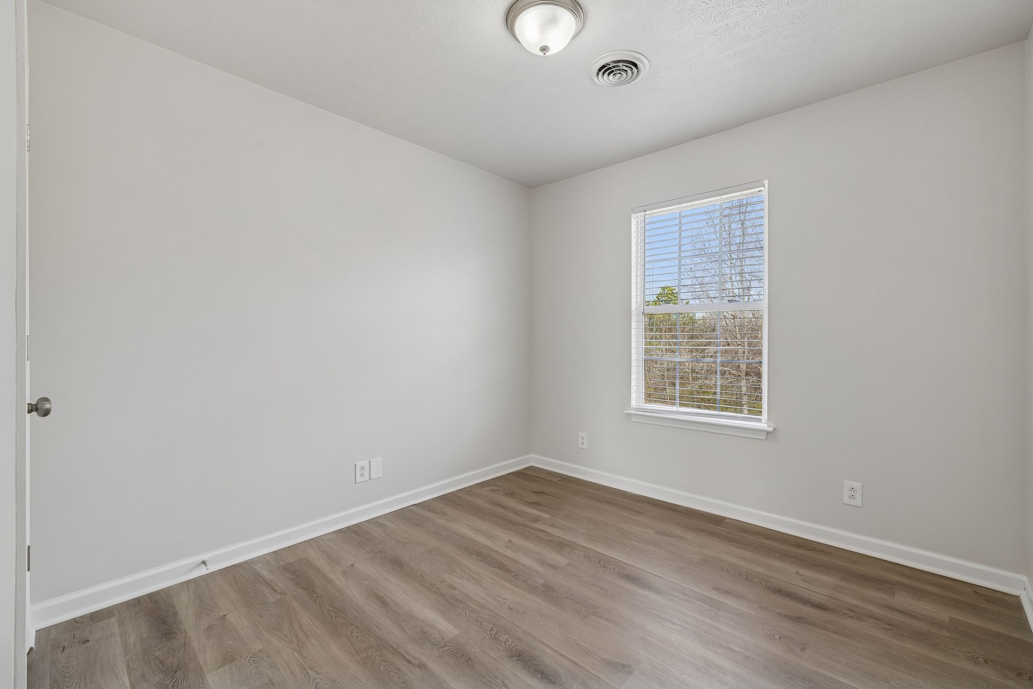 2607 Landrum Court Springfield, TN 37172 - Photo 22 of 37 an empty room with wooden floor and windows
