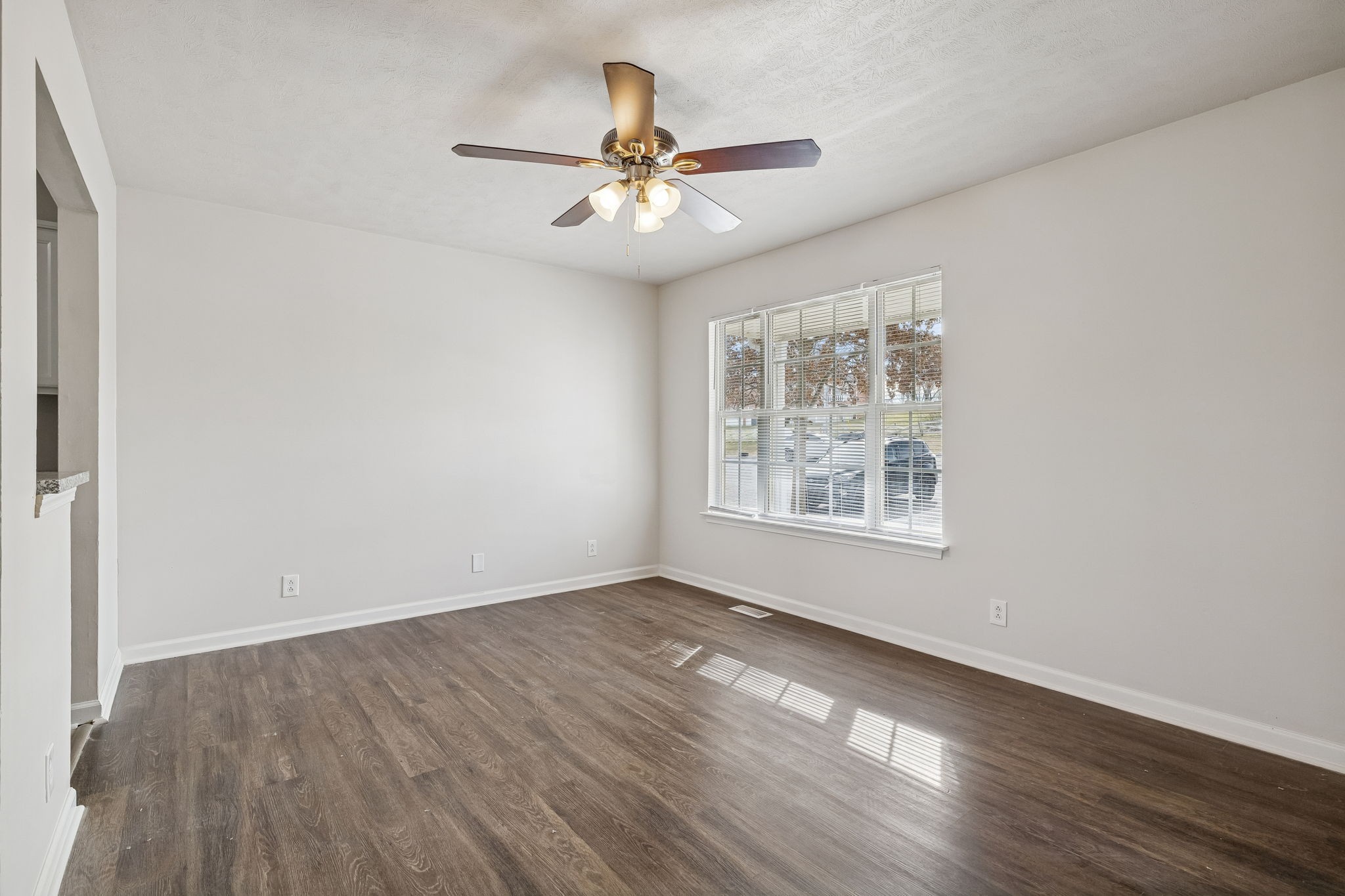 2607 Landrum Court Springfield, TN 37172 - Photo 8 of 37 an empty room with wooden floor chandelier fan and windows