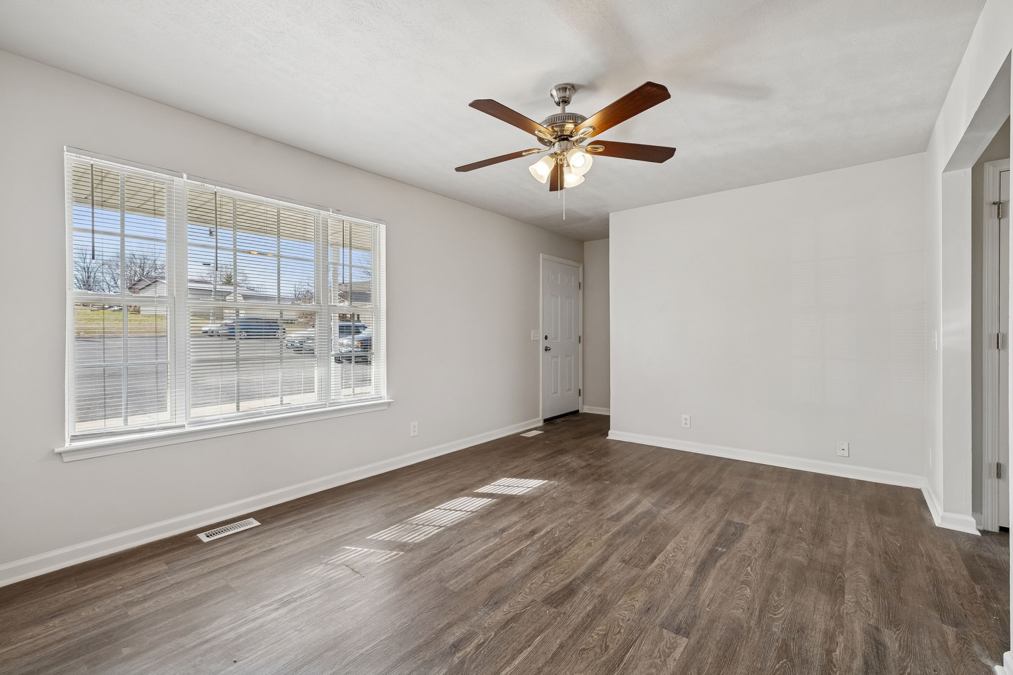 2607 Landrum Court Springfield, TN 37172 - Photo 9 of 37 a view of an empty room with wooden floor and a window