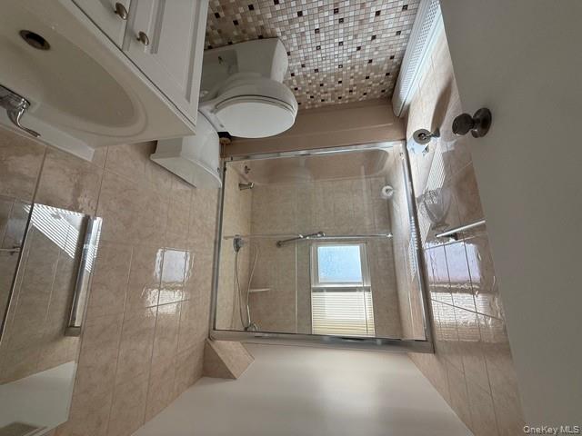 306 Hamilton Avenue, Unit 1 Hewlett, NY 11557 - Photo 14 of 18 a bathroom with a sink toilet and shower
