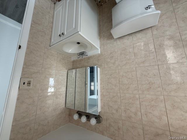 306 Hamilton Avenue, Unit 1 Hewlett, NY 11557 - Photo 15 of 18 a bathroom with a sink a toilet and shower