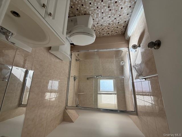 306 Hamilton Avenue, Unit 1 Hewlett, NY 11557 - Photo 16 of 18 a bathroom with a sink toilet and shower