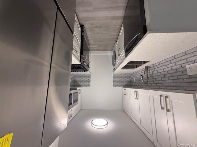 306 Hamilton Avenue, Unit 1 Hewlett, NY 11557 - Photo 5 of 18 a kitchen with stainless steel appliances granite countertop a sink stove and refrigerator