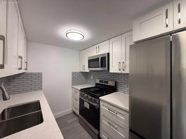 a kitchen with a sink stove and refrigerator