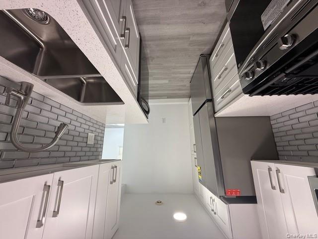 306 Hamilton Avenue, Unit 1 Hewlett, NY 11557 - Photo 7 of 18 a kitchen that has a sink and a stove